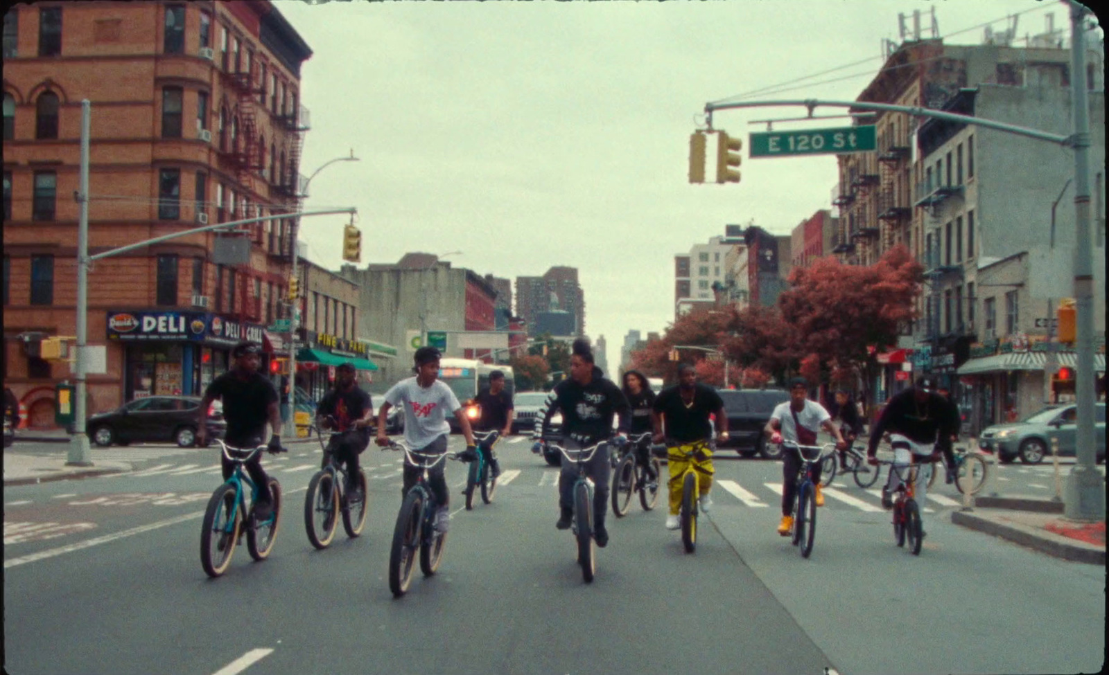 a group of people riding bikes down a street