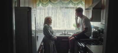 a man standing next to a woman in a kitchen