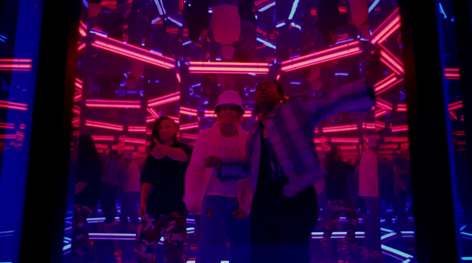 a group of people standing in a room with neon lights