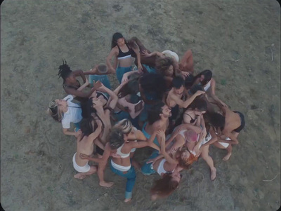 a group of women standing around each other in a circle