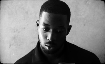 a black and white photo of a man making a face