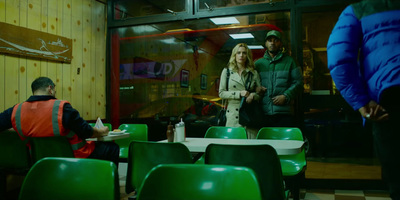 a group of people sitting around a table in a restaurant