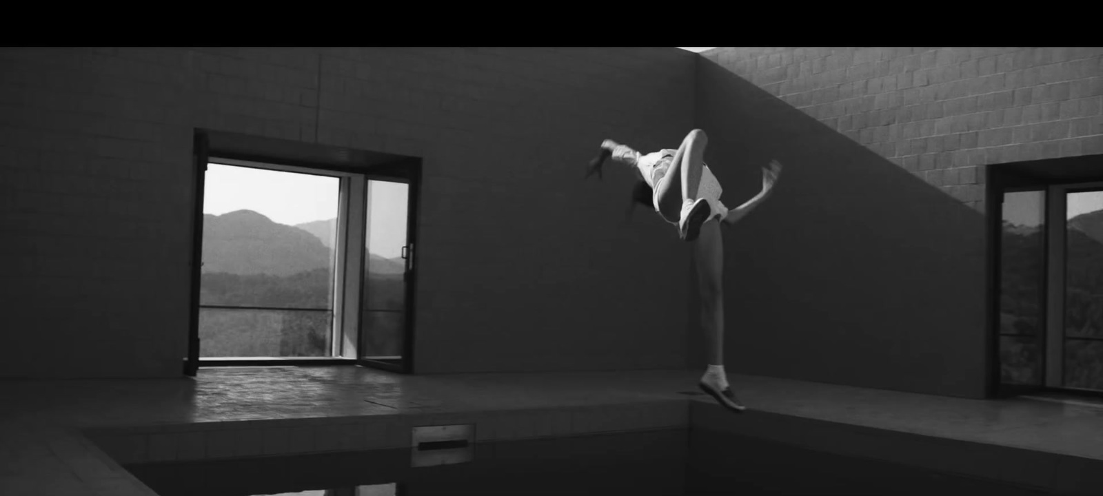 a black and white photo of a person standing in a room