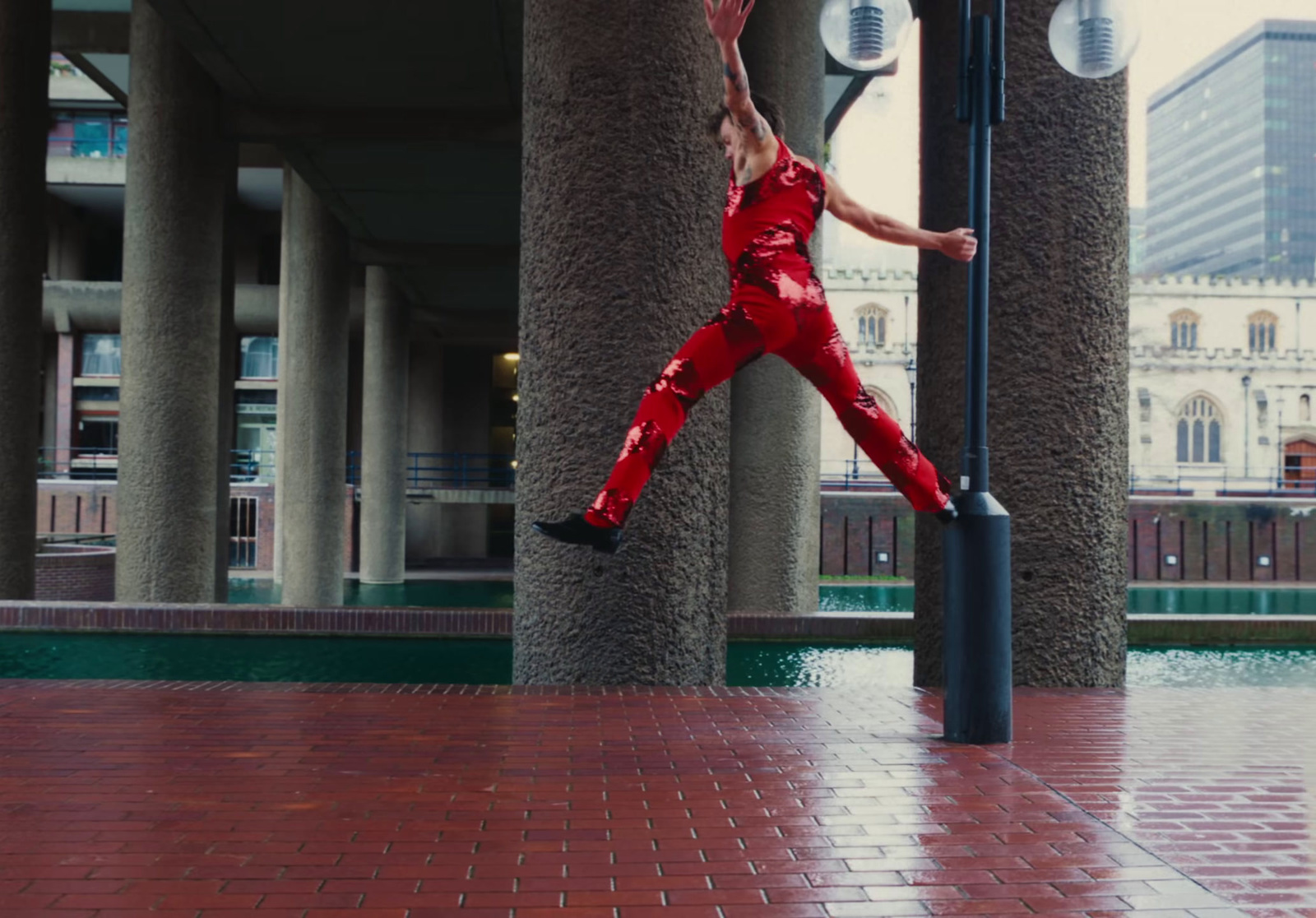 a man in a red suit jumping up into the air