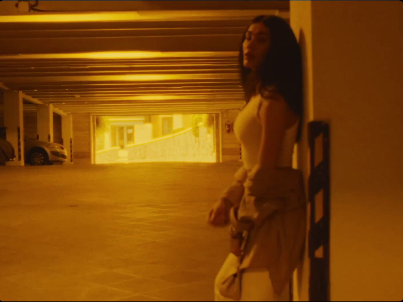 a woman is standing in a parking garage