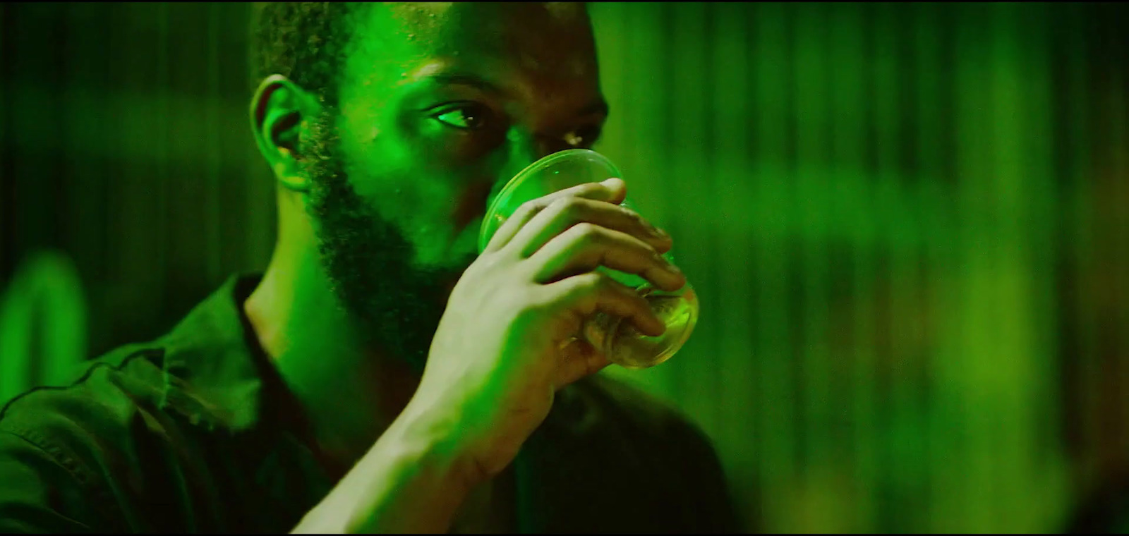 a man with a beard drinking from a bottle