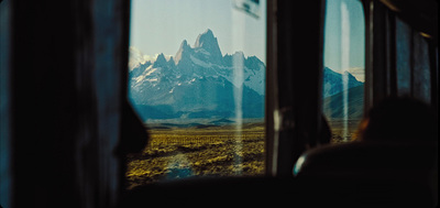 a view of a mountain range from a train window