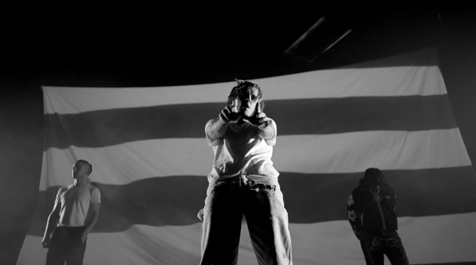 a woman standing in front of a giant american flag