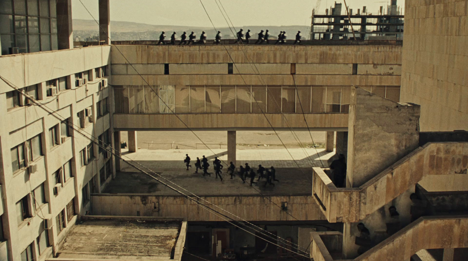 a group of people standing on top of a building