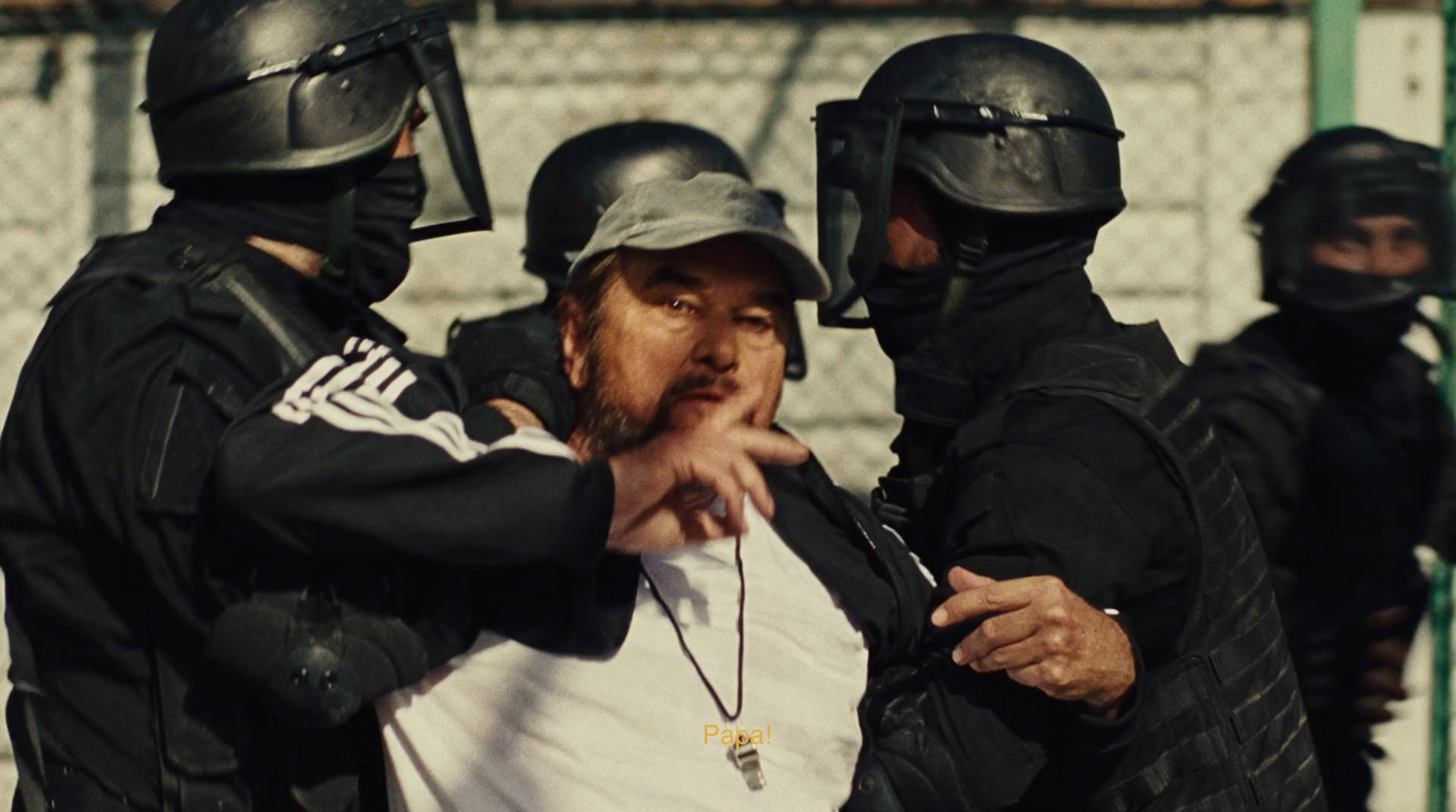 a man in a white shirt is surrounded by police