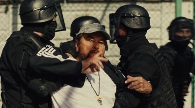 a man in a white shirt is surrounded by police