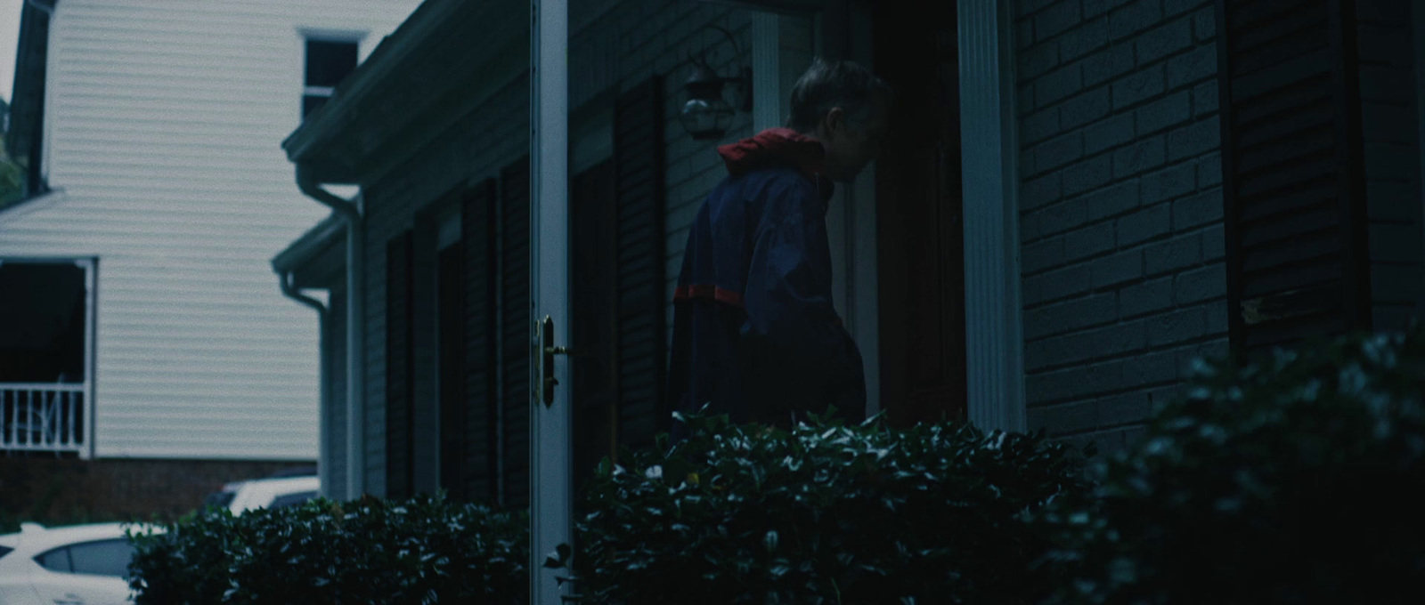 a person standing at the door of a house