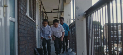 a group of young men walking down a sidewalk