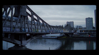 a bridge over a river with graffiti on it