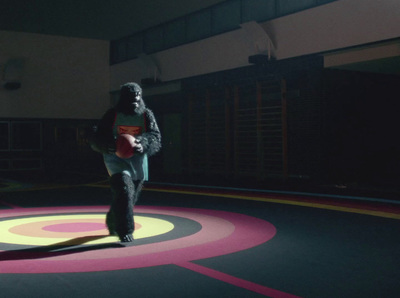 a person walking in a dark room with a circular pattern on the floor