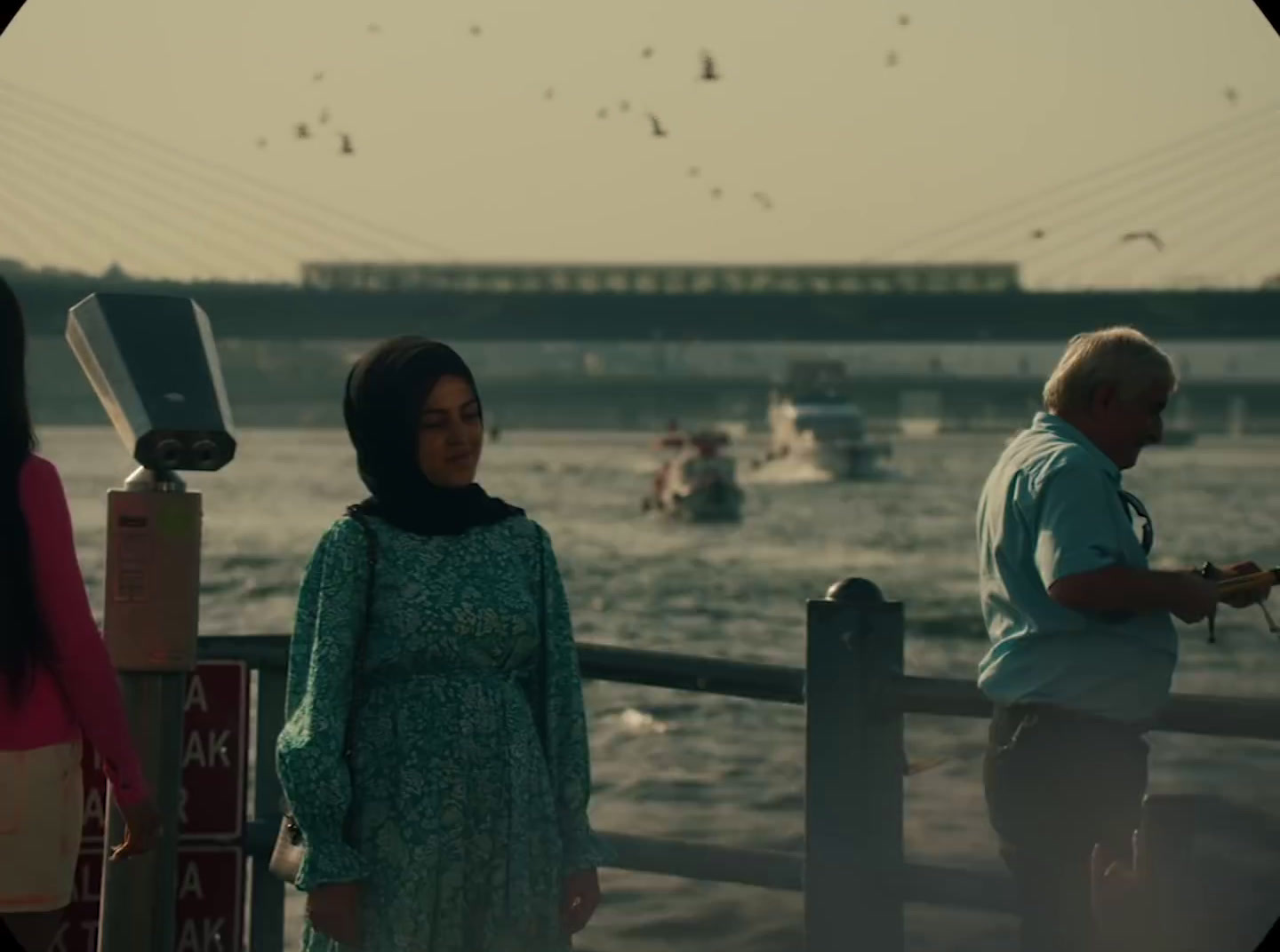 a man and a woman standing next to each other near a body of water