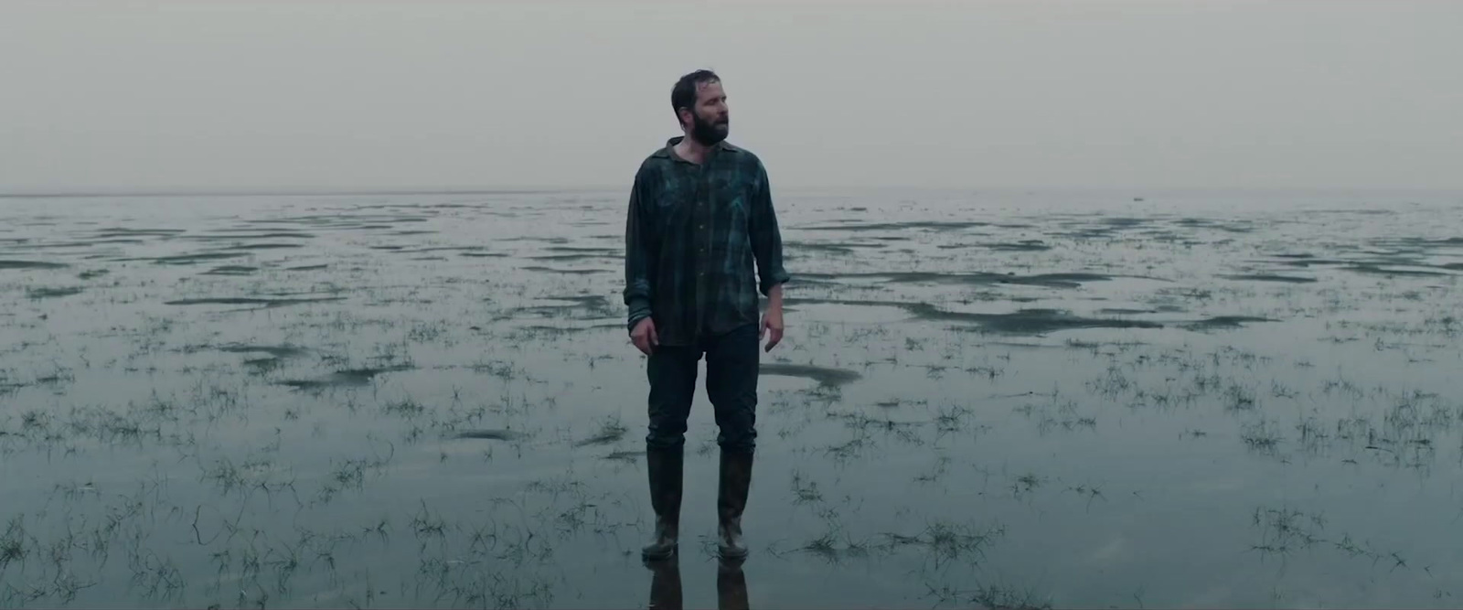 a man standing in the middle of a body of water