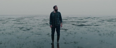 a man standing in the middle of a body of water