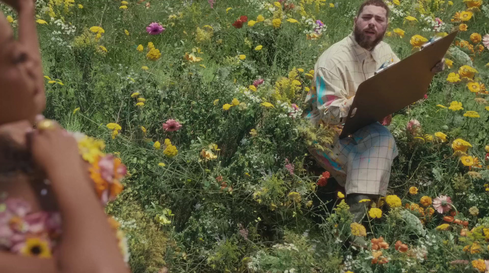 a man and a woman in a field of flowers