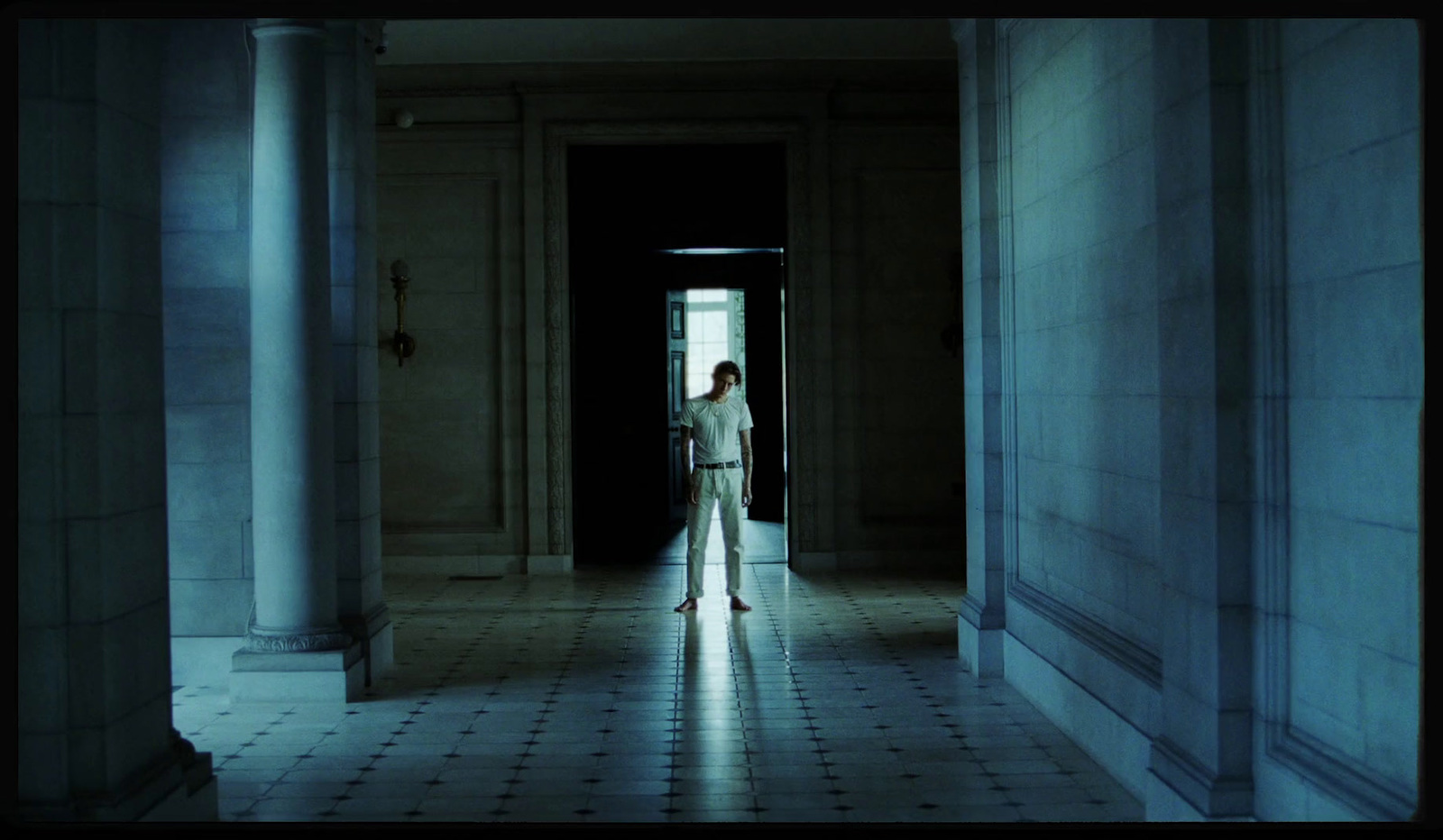 a woman in a white dress standing in a doorway