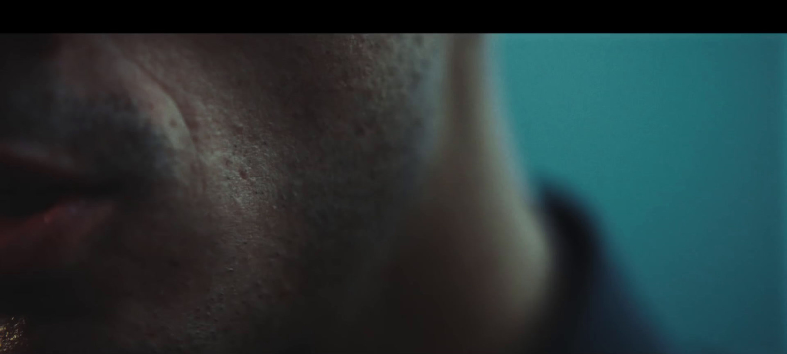 a close up of a man's face with a toothbrush in his mouth