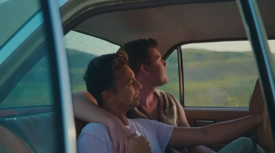 a man and a woman sitting in a car