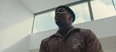 a man with a hat looking up at the sky