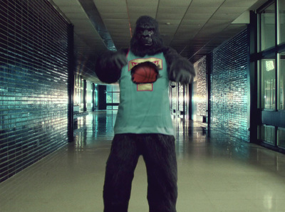 a man in a gorilla suit holding a basketball