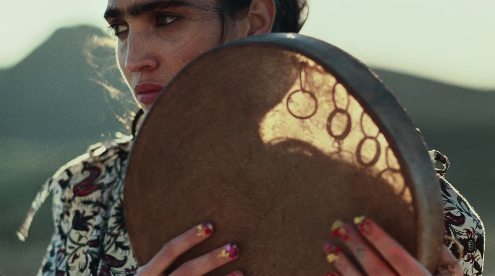 a woman holding a large wooden object in her hands