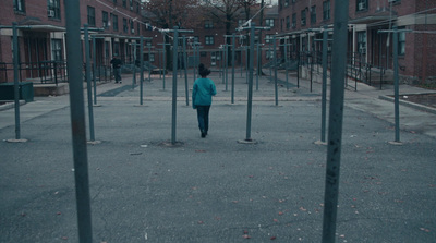 a person standing in a courtyard between two buildings