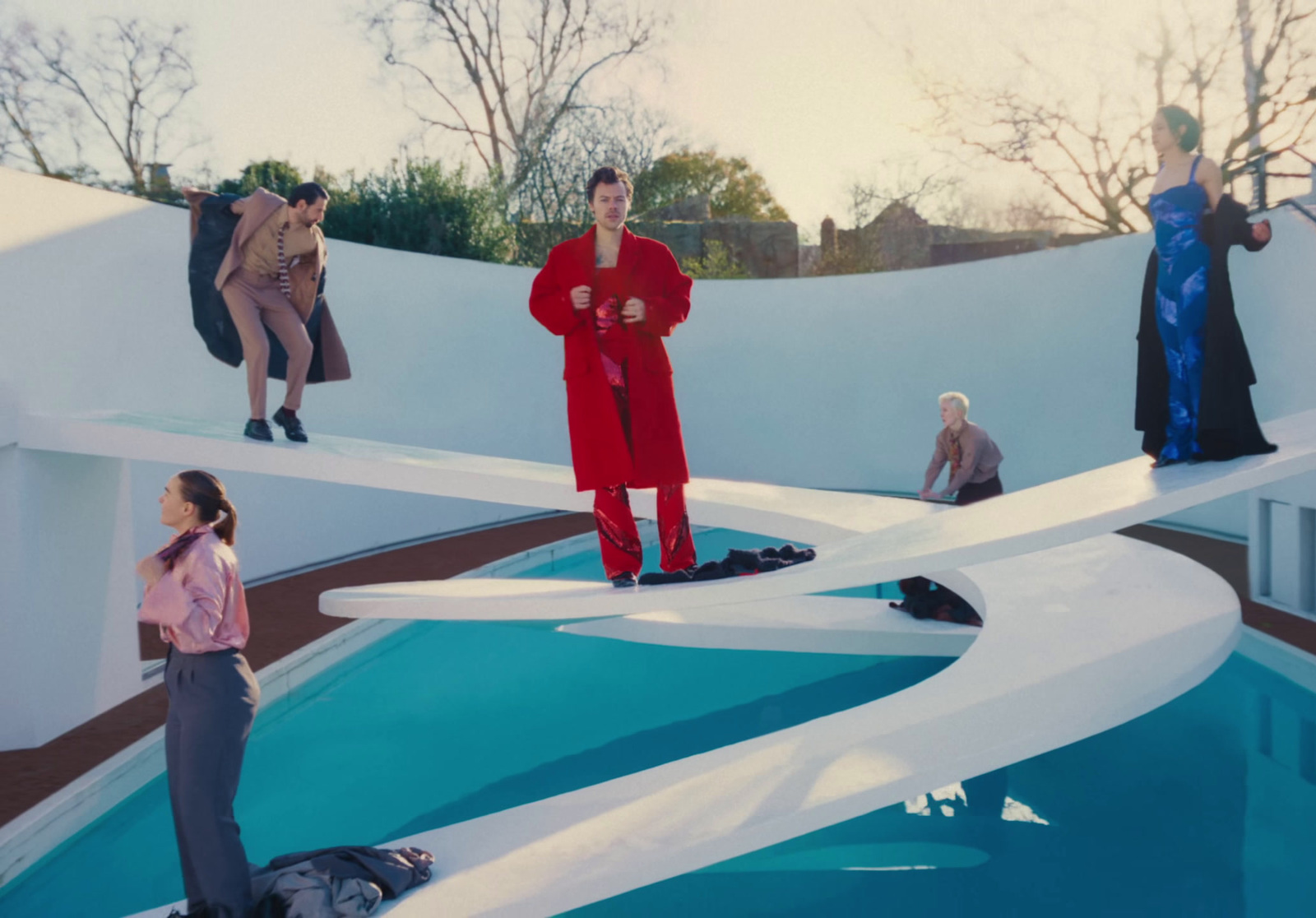 a group of people standing around a pool