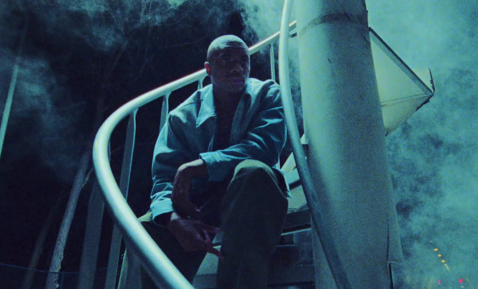 a man sitting on top of a stair case