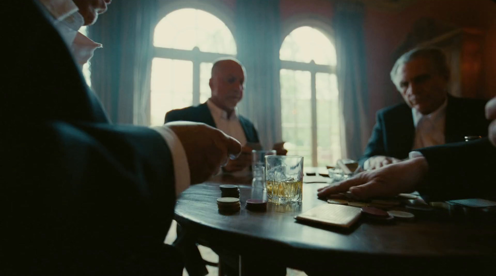 a group of men sitting around a wooden table