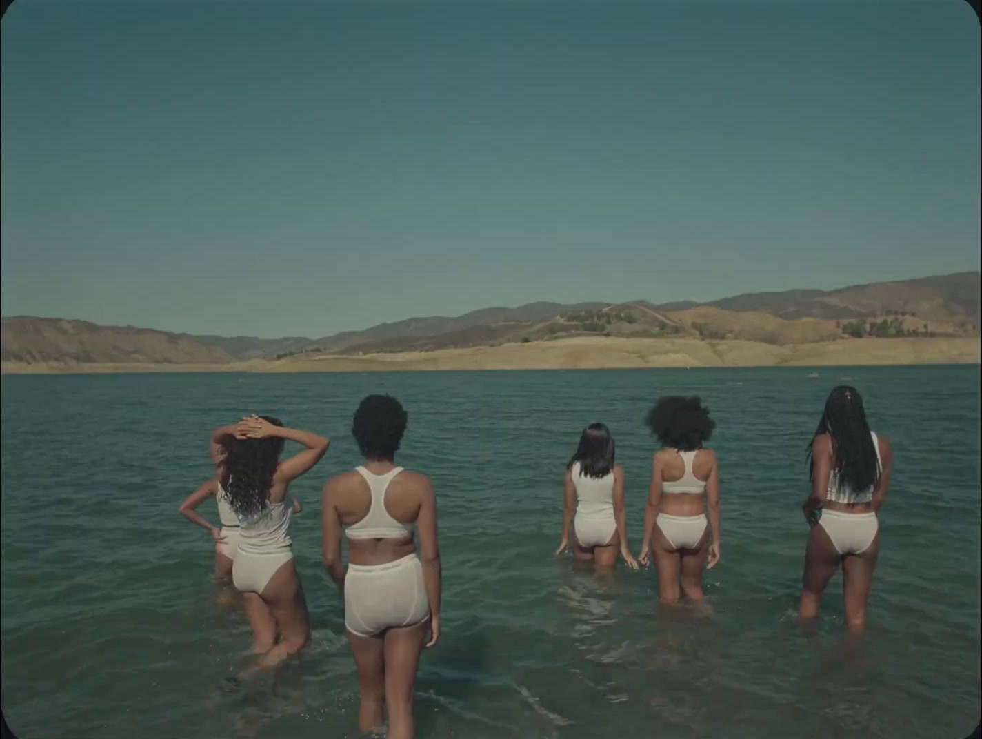 a group of women standing in the water