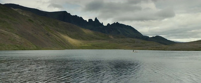 a body of water with mountains in the background