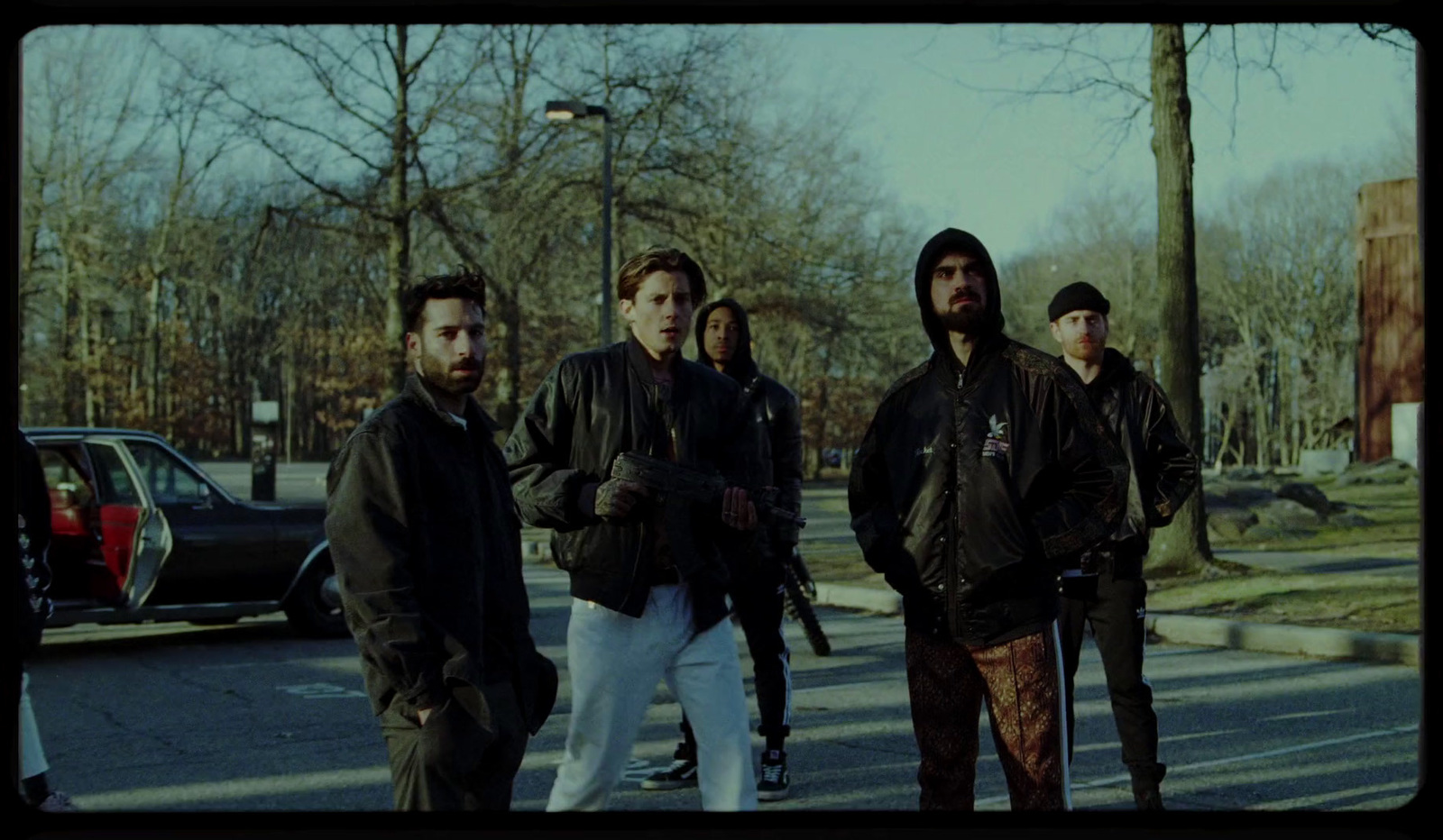 a group of men standing on the side of a road