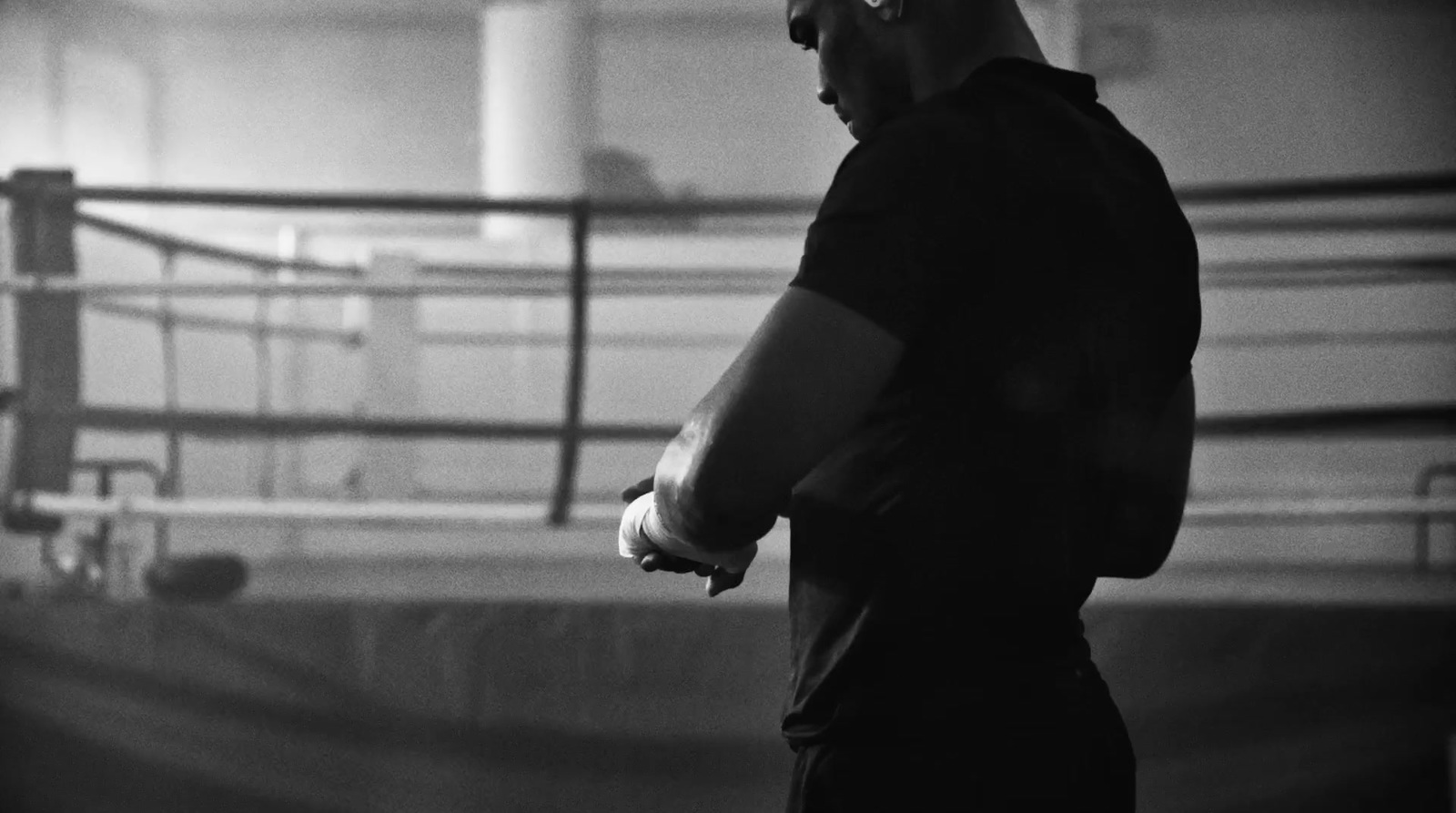 a black and white photo of a man in a boxing ring