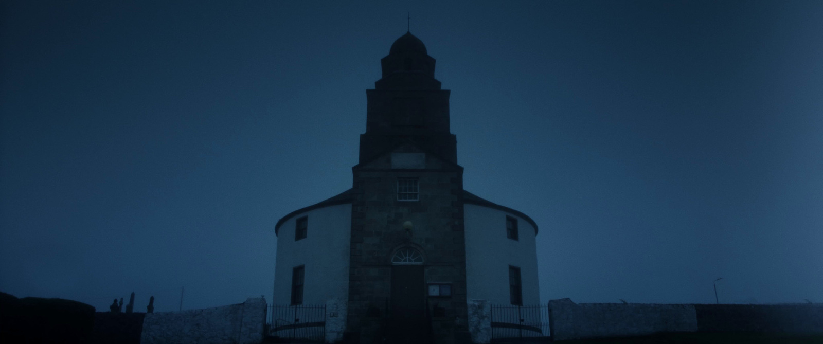 a tall tower with a clock on the top of it