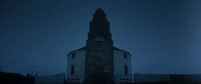 a tall tower with a clock on the top of it