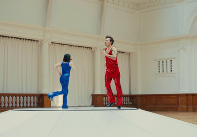 a man in a red suit and a woman in a blue jumpsuit