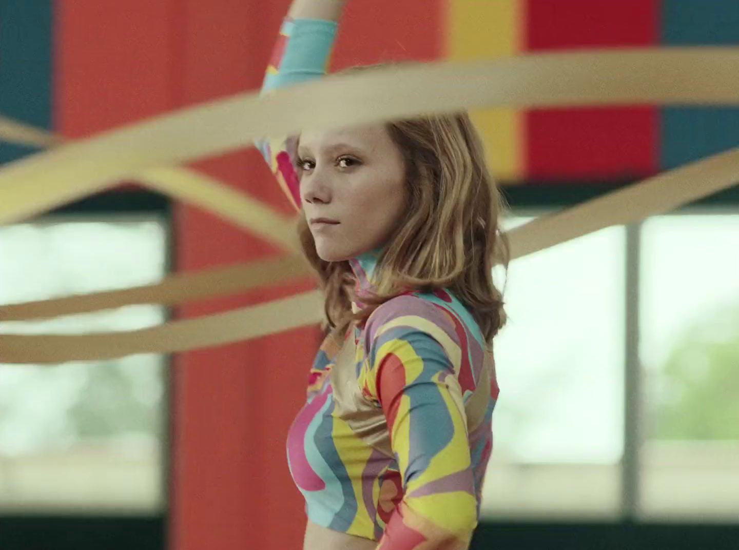 a woman in a colorful shirt holding a frisbee