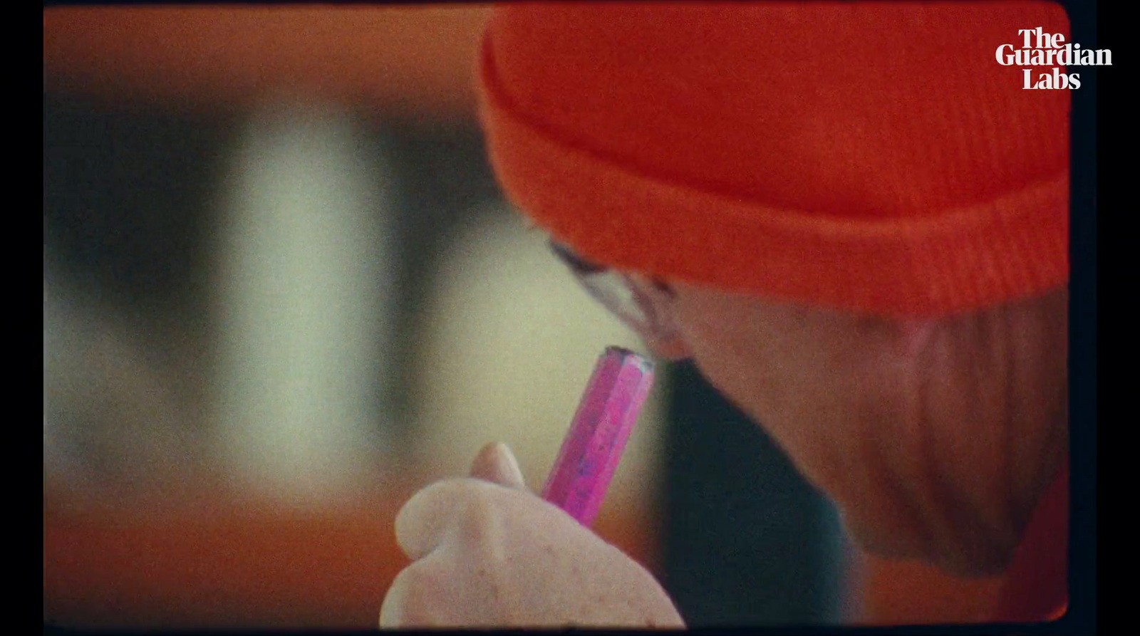 a close up of a person holding a pink pen