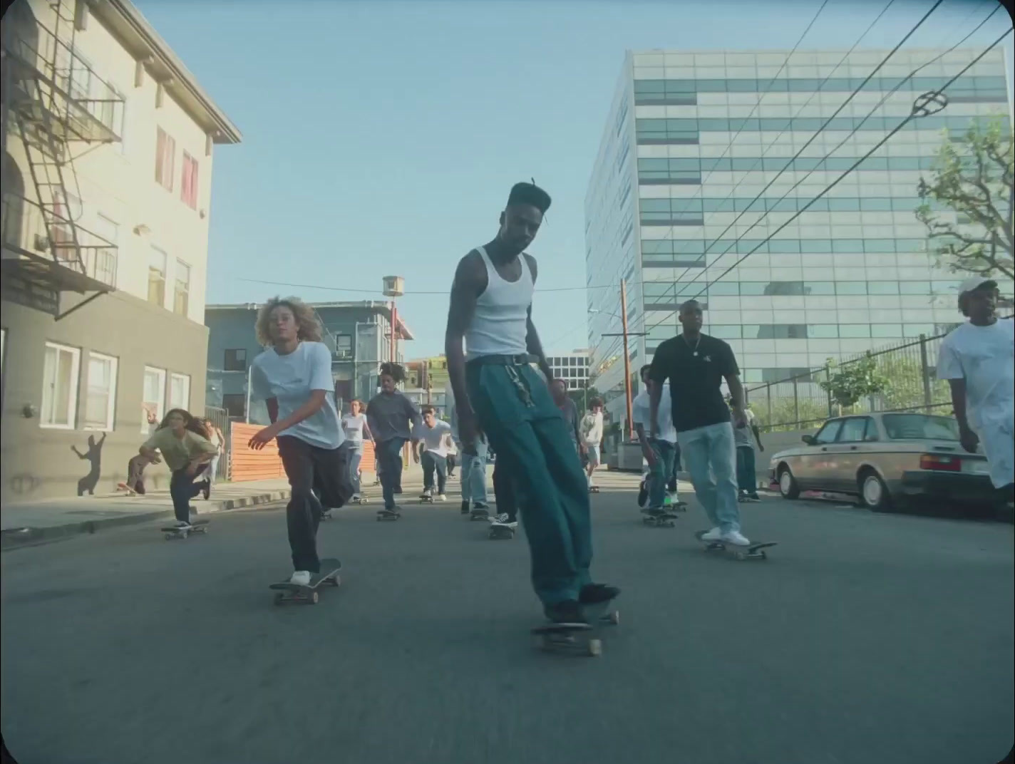 a group of young men riding skateboards down a street