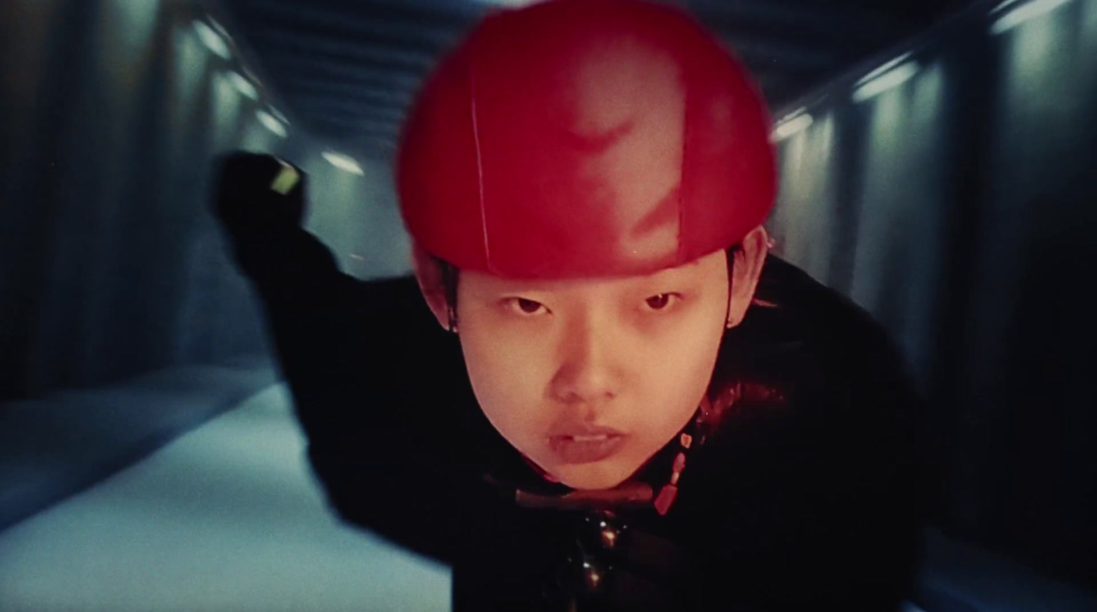 a man wearing a red helmet in a tunnel