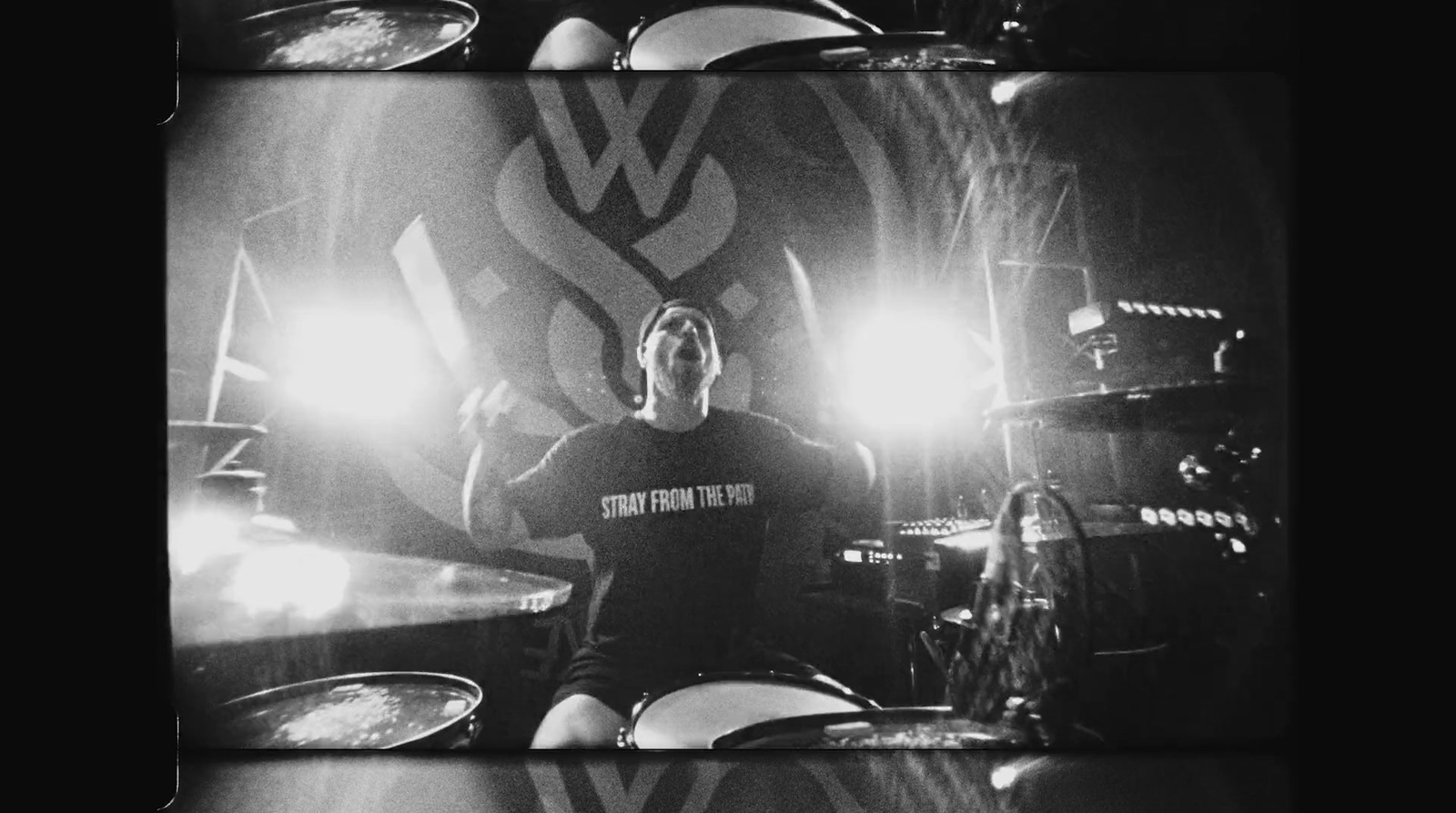 a man sitting in front of a drum set