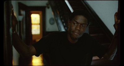 a man in a black shirt standing in a hallway