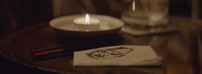 a table with a candle and a napkin on it