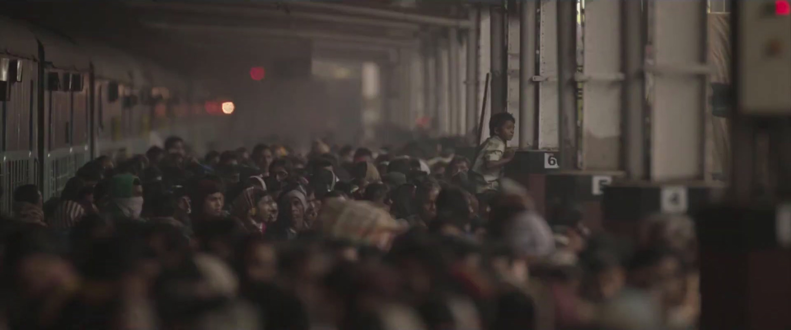 a crowd of people standing next to a train