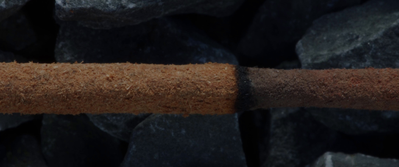 a piece of wood sitting on top of a pile of rocks