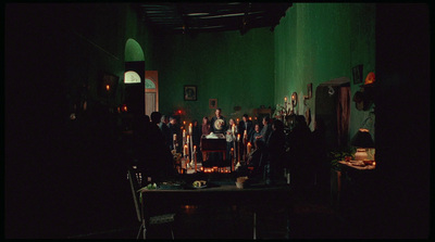 a group of people standing around a table with candles